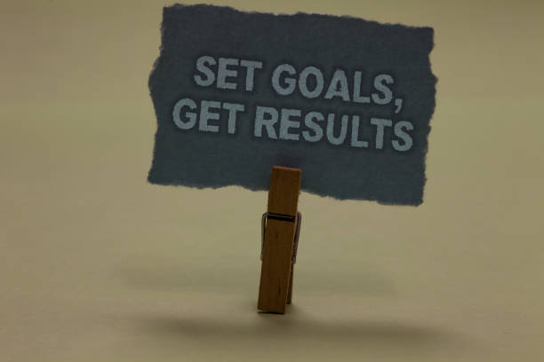 istock Handwriting text writing Set Goals, Get Results. Concept meaning Establish objectives work for accomplish them Paperclip retain ash color written torn thick page on shadow ash floor. 1063948446