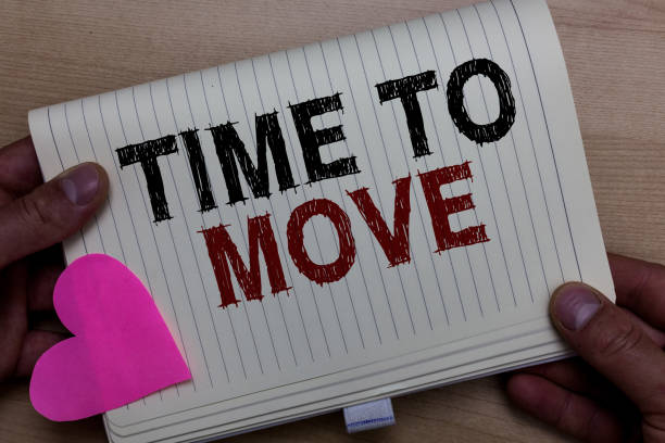istock Word writing text Time To Move. Business concept for Best period to transfer Relocation Change the current path Man holding notebook paper heart Romantic ideas messages Wooden background. 1063948700