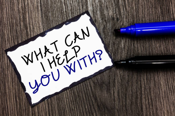 istock Word writing text What Can I Help You With question. Business concept for Offering assistance Experts advice ideas Black bordered page with texts laid black and blue pen on wooden floor. 1063948704