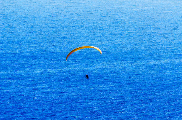 istock Paraglider flying in the sky free time spent actively wonderful experiences vacation 1063949952