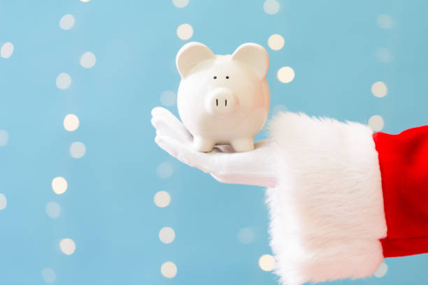 istock Santa holding a piggy bank 1063950170