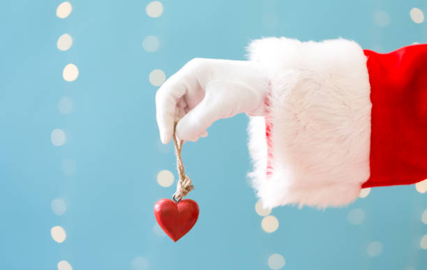 istock Santa holding a Christmas heart 1063950188