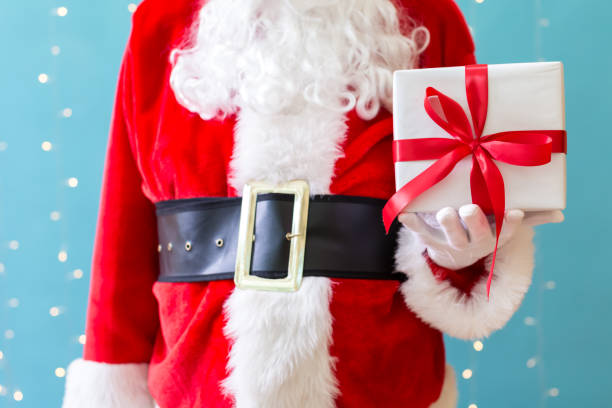 istock Santa holding a Christmas gift 1063950234