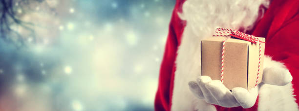 istock Santa Claus holding gift 1063950244