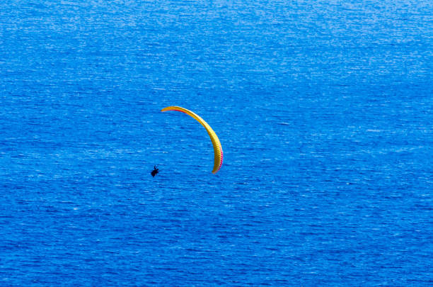 istock Paraglider flying in the sky free time spent actively wonderful experiences vacation 1063951012