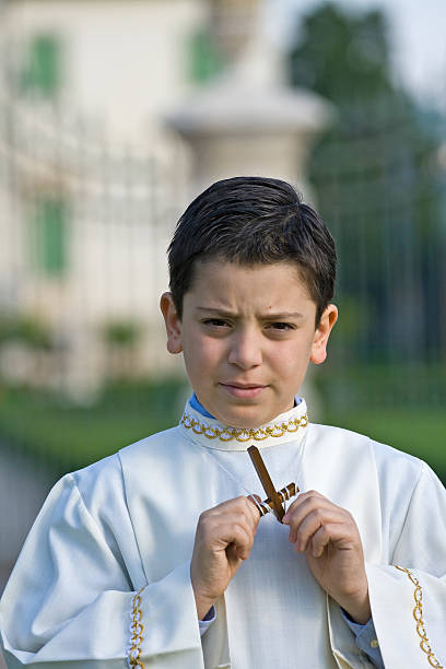 istock Young child holding Jesus cross on first communion event. 106395237