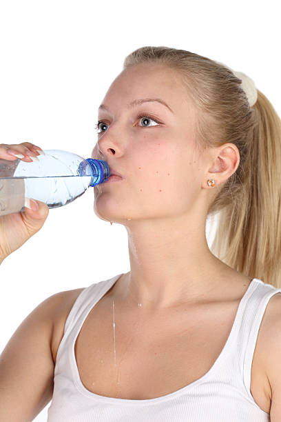 istock beautiful girl drinks mineral water from plastic bottle 106395418