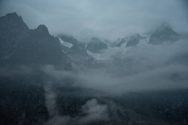 istock Mountain partly engulfed in clouds with river leading into the picture 1063966092