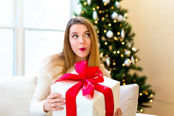 istock Happy woman holding a big gift box 1063968098