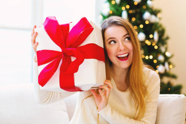 istock Happy woman holding a big gift box 1063968118