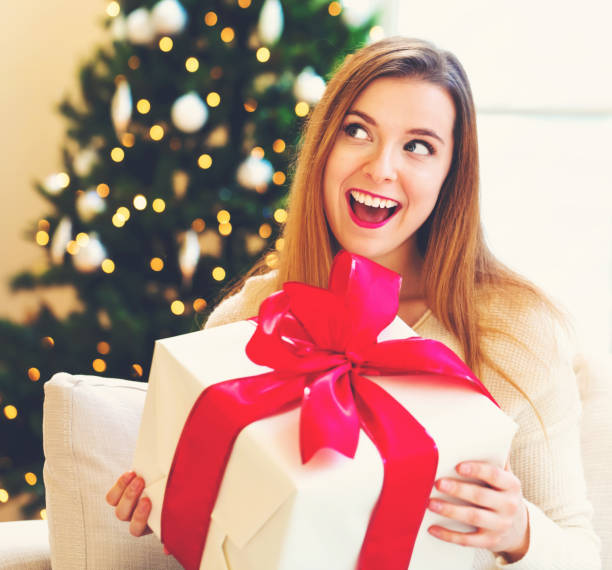 istock Happy woman holding a big gift box 1063968130