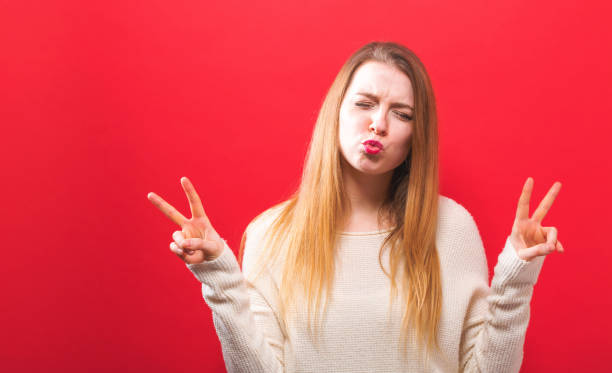 istock Young woman giving the peace sign 1063968148