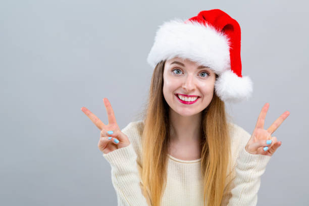 istock Happy woman with a Santa hat 1063968244