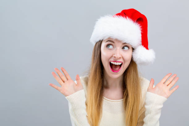 istock Happy woman with a Santa hat 1063968292