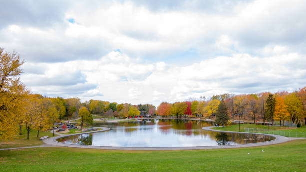 Beaver lake at the top of Mont-Royal, as foliage bursts with autumn colors. Montreal, Canada stock photo