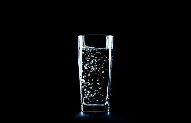 istock pour water background black. with blurry background 1063978028