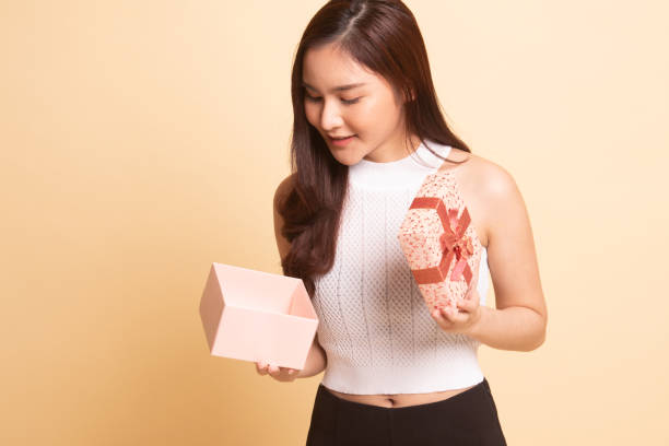 istock Young Asian woman open a gift box. 1063990956