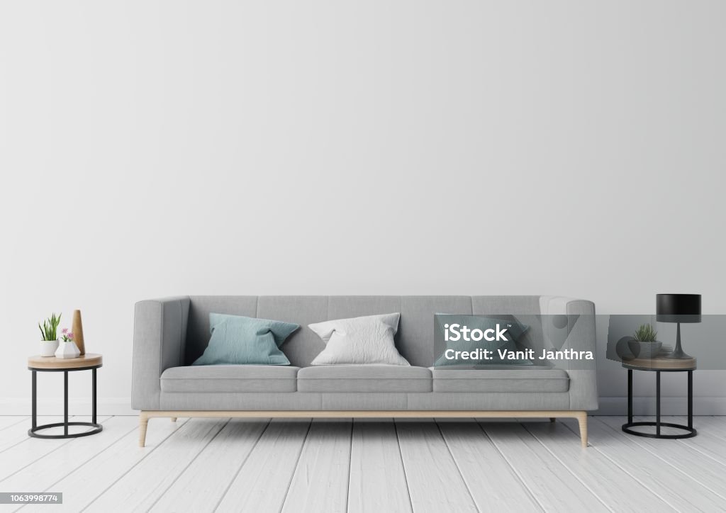 Gray sofa and wooden table Gray sofa and wooden table with flower,lamp on the stumps in empty wall in simple living room interior,3d rendering Sofa Stock Photo