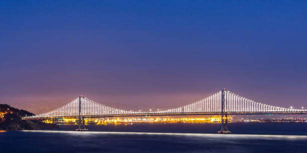 istock Glowing Bay Bridge over San Francisco bay at night 1064001964