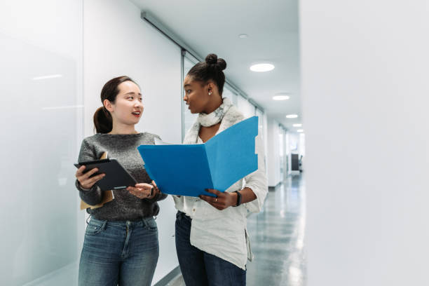 istock Women walking and talking in the office 1064007116