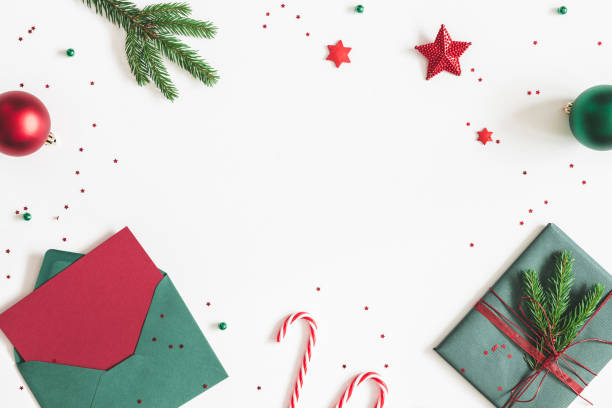 istock Christmas composition. Envelope, fir tree branches, red and green decorations on white background. Christmas, winter, new year concept. Flat lay, top view, copy space 1064021520