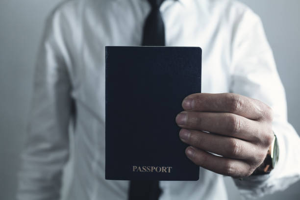 istock Caucasian businessman holding passport. 1064021766