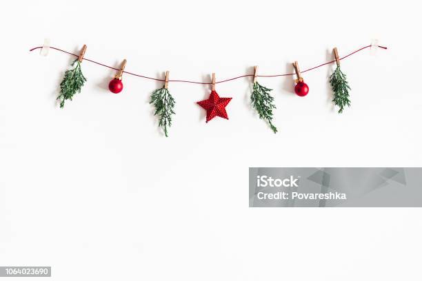 Christmas Composition Garland Made Of Red Balls And Fir Tree Branches On White Background Christmas Winter New Year Concept Flat Lay Top View Copy Space Stock Photo - Download Image Now