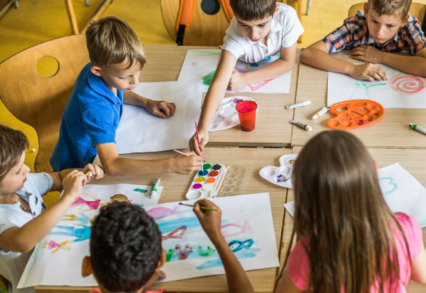 istock Large group of elementary students having an art class in the classroom. 1064027384