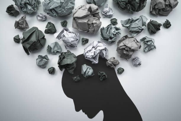 Silhouette of troubled person head. Concept image of anxiety and negative emotion. Waste paper and head silhouette. butterflies in the stomach stock pictures, royalty-free photos & images