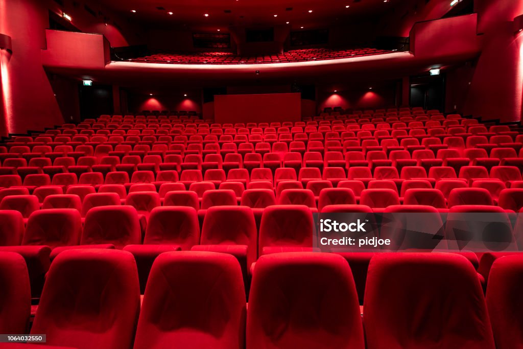 Red seats in theather Cinema theater with Red Seats.
Red and empty theater seats in a row Movie Theater Stock Photo