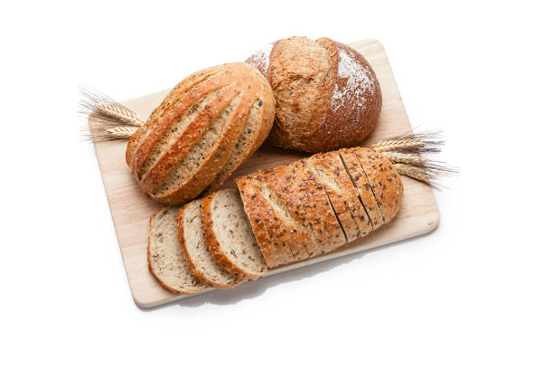 istock Three loaves of bread shot from above on white background 1064033604
