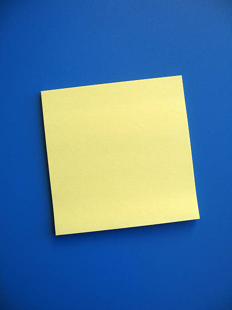 Blank Sticky Note A blank yellow note on blue background. Add your own message. wooden post stock pictures, royalty-free photos & images
