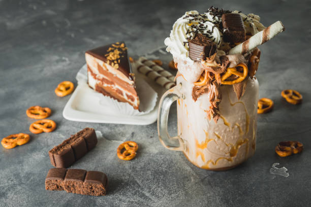 istock Chocolate shake with milk, dripping sauce, cream, cake and cookie 1064039938