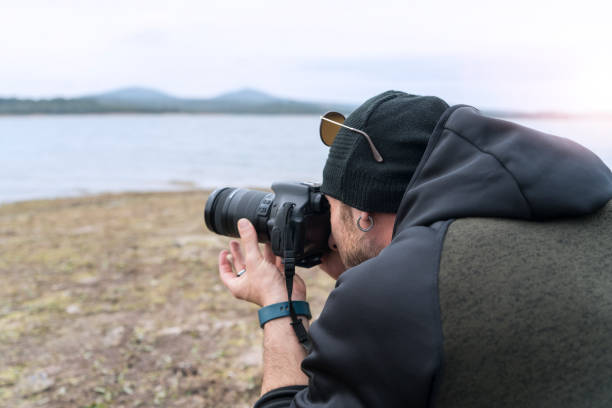 istock camping,lake,man,photographer 1064041538