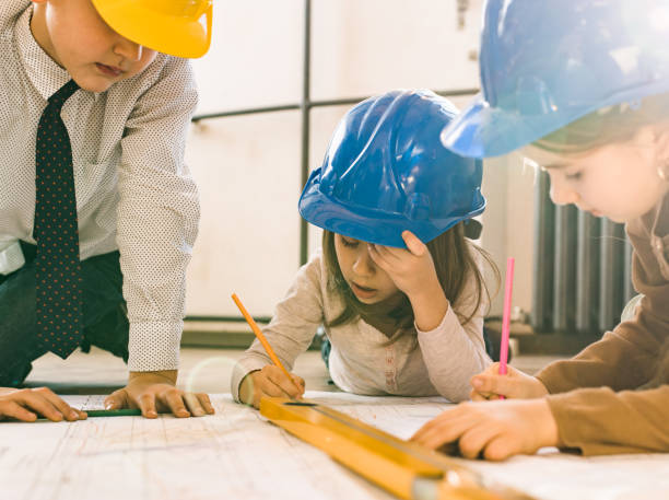 istock Team of small architects working on blueprints in the office. 1064042736