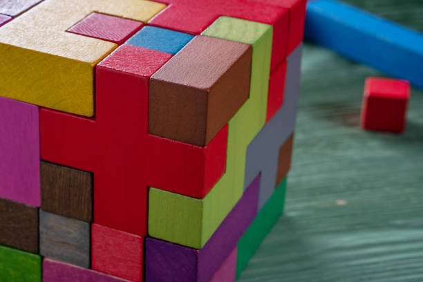 istock The cube is made up of multi-colored wooden shapes. 1064042786