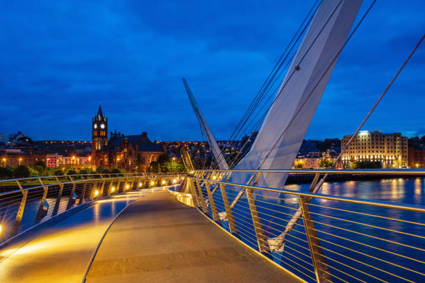 istock Illuminated Peace Bridge in Derry (Londonderry) at Night Northern Ireland 1064042808