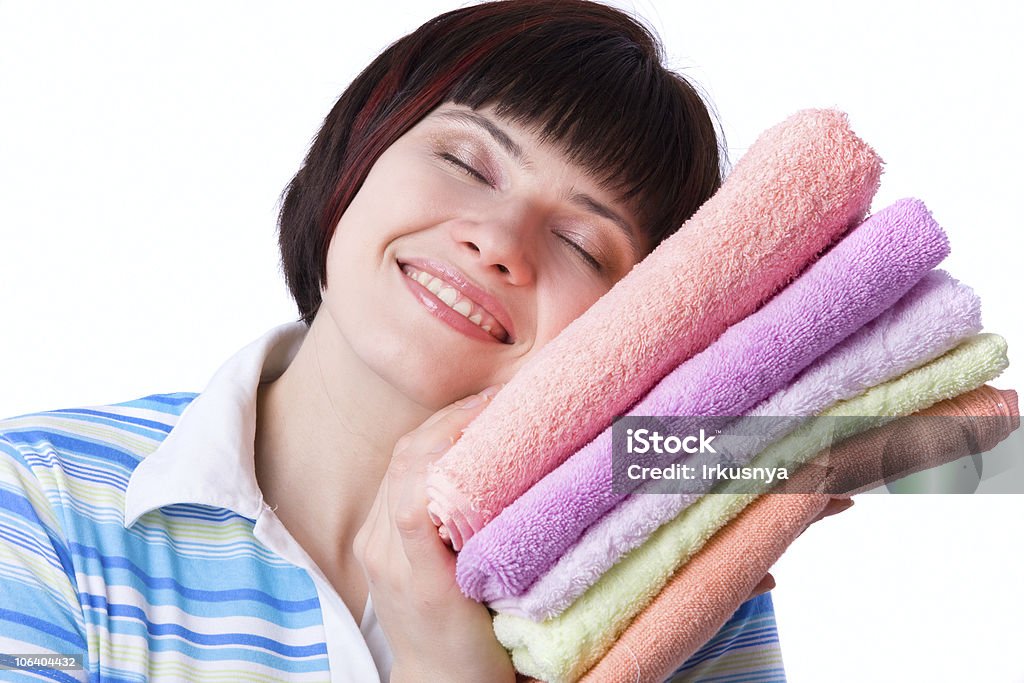 Time for laundry day. Housewife with clean laundry.  A young woman holding clean towels. Time for laundry day. Cleaning Stock Photo