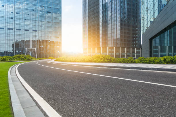 istock empty asphalt road front of modern buildings 1064045378