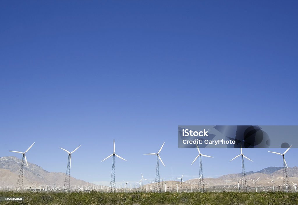 Seven Turbines Seven old-style steel-trussed wind turbines with hundreds of turbines in the background. The San Gorgonio Pass wind farm near Palm Springs, CA. Blade Stock Photo