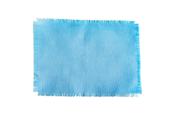 Blue fabric cut texture, background with frayed edges, napkin isolated on white background,