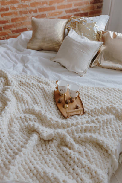 istock Wooden tray with coffee on bed 1064058690