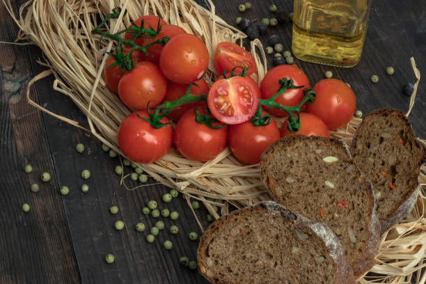 istock composition of small red cherry tomatoes on an old wooden table in a rustic style, selective focus.season of vegetables. 1064059554