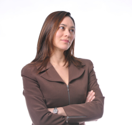 Young women has her arms crossed.She is of filipino ethnicity.Wearing a brown suit and has long brown hair.Her head is turn sideways.It is on a white background.She has a small smile.