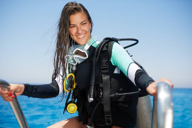 istock Scuba diver girl climbing 1064065574