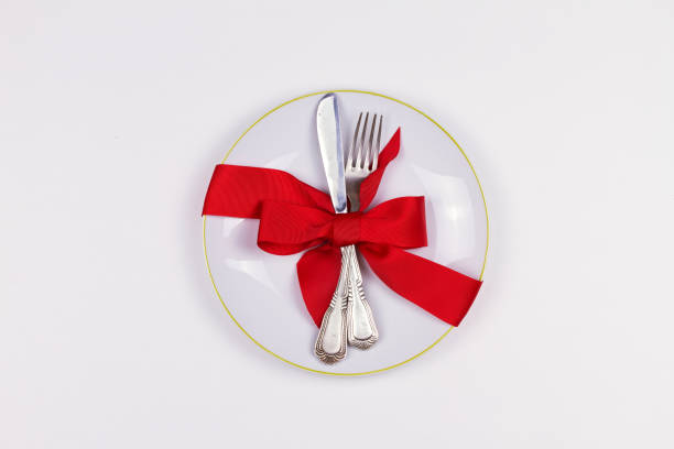 istock Christmas composition with plate, cutlery, pine branches, ribbon and red berries on white table 1064066336