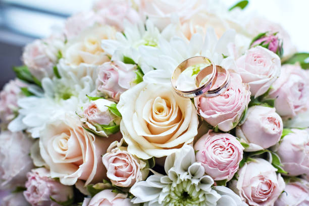 istock Wedding bouquet with roses and wedding rings 1064066432