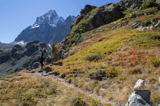 istock Couple hiking in mountains, footpath in foreground 1064068310