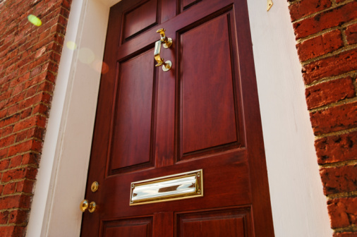 Close-up view of Mail box and door knocker on  wooden front door. Valença do Minho, Portugal.