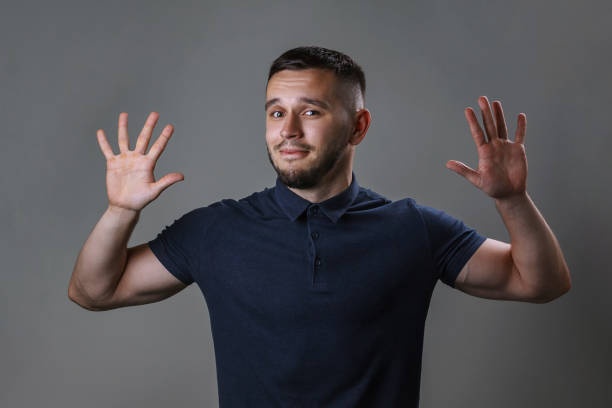istock Studio portrait of a young man keep hands up before him with the expression 